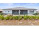Back exterior view with green chain link fence and covered screened patio at 9262 Sw 102Nd Avenue Rd, Ocala, FL 34481