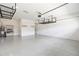 Clean garage with epoxy flooring, overhead storage, and an adjacent utility area at 9262 Sw 102Nd Avenue Rd, Ocala, FL 34481