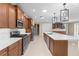 An open kitchen featuring a large island, stainless steel appliances, and neutral color palette at 9262 Sw 102Nd Avenue Rd, Ocala, FL 34481