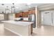 Modern kitchen featuring a large island, stainless steel appliances, and lots of wood cabinets at 9262 Sw 102Nd Avenue Rd, Ocala, FL 34481