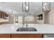 Bright kitchen features a spacious island, stainless steel sink, and modern lighting fixtures at 9262 Sw 102Nd Avenue Rd, Ocala, FL 34481