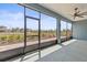 Screened patio with ceiling fan and outdoor views of the lawn, landscaping, and neighboring houses at 9262 Sw 102Nd Avenue Rd, Ocala, FL 34481