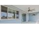 View of the covered patio featuring a ceiling fan and sliding glass doors for seamless indoor-outdoor living at 9262 Sw 102Nd Avenue Rd, Ocala, FL 34481