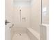 Bright and modern shower with bench, handheld shower fixture, and tiled walls at 9262 Sw 102Nd Avenue Rd, Ocala, FL 34481