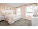 Light-filled bedroom with soft peach walls, decorative pillows, and elegant decor, creating a calming retreat at 1310 Whispering Ln, Minneola, FL 34715