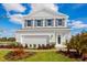 Charming two-story home featuring a clean gray exterior, complemented by dark shutters and a well-manicured front yard at 1310 Whispering Ln, Minneola, FL 34715