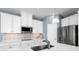 Well-equipped kitchen featuring sleek countertops, stainless steel appliances, and ample cabinet space for storage at 1310 Whispering Ln, Minneola, FL 34715