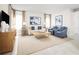 Inviting living room featuring comfortable seating, neutral tones, and large windows for ample natural light at 1310 Whispering Ln, Minneola, FL 34715