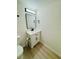 Powder room featuring modern vanity with marble countertop, mirror, and wood floors at 232 Thomas Ave, Frostproof, FL 33843