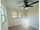 Bedroom with ample natural light, a ceiling fan, and light hardwood floors at 232 Thomas Ave, Frostproof, FL 33843