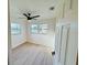 Inviting bedroom with light hardwood floors, two large windows, and a modern ceiling fan at 232 Thomas Ave, Frostproof, FL 33843