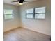Well-lit bedroom with a ceiling fan and light hardwood floors at 232 Thomas Ave, Frostproof, FL 33843