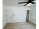 This bedroom has a ceiling fan, light hardwood floors and a closet at 232 Thomas Ave, Frostproof, FL 33843