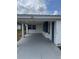 A covered carport provides convenient parking next to the home's entrance at 232 Thomas Ave, Frostproof, FL 33843