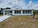 Charming single-story home featuring a metal roof, carport, and multiple windows at 232 Thomas Ave, Frostproof, FL 33843
