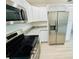 Modern kitchen featuring stainless appliances, granite countertops, and updated cabinetry at 232 Thomas Ave, Frostproof, FL 33843