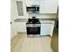 Well-equipped kitchen with stainless steel appliances, granite countertops, and white cabinets at 232 Thomas Ave, Frostproof, FL 33843