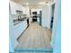 Renovated kitchen features stainless steel appliances, granite counters, and modern cabinets at 232 Thomas Ave, Frostproof, FL 33843