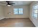 Bright, airy living room featuring new floors, white walls and large windows for ample natural light at 232 Thomas Ave, Frostproof, FL 33843