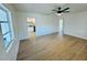 Spacious living room showcasing new flooring and fresh paint, offering a seamless transition to the adjacent kitchen at 232 Thomas Ave, Frostproof, FL 33843