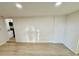 Open-concept living room with wood floors next to modern kitchen and white walls at 232 Thomas Ave, Frostproof, FL 33843
