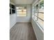 Sunroom featuring new floors and multiple windows, allowing natural light to fill the space at 232 Thomas Ave, Frostproof, FL 33843
