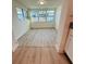 Bright sunroom featuring vinyl plank flooring and windows offering ample natural light at 232 Thomas Ave, Frostproof, FL 33843
