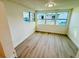 Bright sunroom featuring vinyl plank flooring and windows offering ample natural light at 232 Thomas Ave, Frostproof, FL 33843
