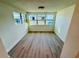 Bright sunroom featuring vinyl plank flooring and windows offering ample natural light at 232 Thomas Ave, Frostproof, FL 33843