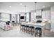 Open-concept kitchen and living area featuring a center island with seating and modern appliances at 3758 Voyageurs Ct, Apopka, FL 32712