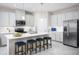 Well-lit kitchen featuring stainless steel appliances, a center island with seating, and ample cabinetry at 3758 Voyageurs Ct, Apopka, FL 32712