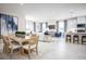 Open-concept dining and living area with a modern kitchen featuring a central island with seating at 3758 Voyageurs Ct, Apopka, FL 32712