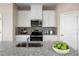 Granite countertops, stainless appliances, and white cabinetry highlight this bright and modern kitchen at 7088 Lanier Falls Rd, Deland, FL 32724