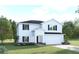 Charming two-story home featuring a two-car garage, well-manicured lawn, and welcoming front entrance at 1385 Laramie Way, Haines City, FL 33844