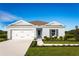 Charming one-story home with a manicured lawn, a two-car garage, and a modern gray exterior paint at 1531 Landon Ln, Haines City, FL 33844