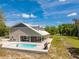 Outdoor space with pool, patio, and lush lawn, showcasing the home's exterior at 13700 Sw 108Th Ln, Dunnellon, FL 34432