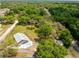 This aerial view captures the home with its inground pool, large yard, and mature trees at 13700 Sw 108Th Ln, Dunnellon, FL 34432