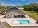 Backyard with a pool, patio area, green grass, and the side of the home at 13700 Sw 108Th Ln, Dunnellon, FL 34432
