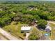 An aerial view shows this property surrounded by large mature trees, and a pond at 13700 Sw 108Th Ln, Dunnellon, FL 34432