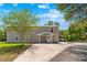 Lovely home exterior featuring a stone-accented entrance and well-kept landscaping at 13700 Sw 108Th Ln, Dunnellon, FL 34432