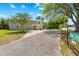 Beautiful home exterior with a well-maintained lawn and a long paved driveway at 13700 Sw 108Th Ln, Dunnellon, FL 34432