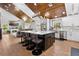 Open concept kitchen island flows into the living area, featuring a fireplace and a warm, inviting atmosphere at 13700 Sw 108Th Ln, Dunnellon, FL 34432