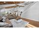 Open-concept living room offers high ceilings, wood flooring, staircase, and bright, natural light at 13700 Sw 108Th Ln, Dunnellon, FL 34432