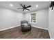 A spacious living room includes hardwood floors, ceiling fan, and a comfortable armchair at 13700 Sw 108Th Ln, Dunnellon, FL 34432