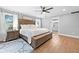 Spacious main bedroom featuring wood floors, a ceiling fan, and an ensuite bathroom at 13700 Sw 108Th Ln, Dunnellon, FL 34432