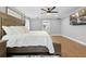 Bright bedroom with wood floors, a large bed, and a view of the ensuite bathroom at 13700 Sw 108Th Ln, Dunnellon, FL 34432