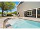 Modern backyard pool with a sleek waterfall feature, ideal for outdoor enjoyment at 13700 Sw 108Th Ln, Dunnellon, FL 34432