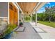 Inviting front porch featuring a wood ceiling and stone accents, perfect for relaxing at 13700 Sw 108Th Ln, Dunnellon, FL 34432