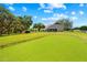 Backyard putting green offers a recreational amenity against the backdrop of the home at 13700 Sw 108Th Ln, Dunnellon, FL 34432