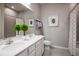 Bathroom with double vanity sinks, modern fixtures, and a shower with patterned curtain at 1556 Covey Rise Ter, Winter Haven, FL 33884